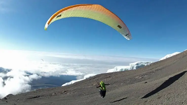 Paraglider launching from the Kilimanjaro crater rim